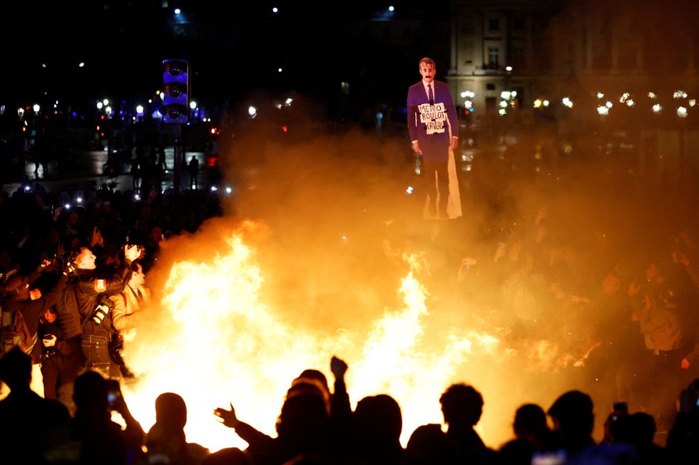 An effigy of Macron burns as protests continues in Paris