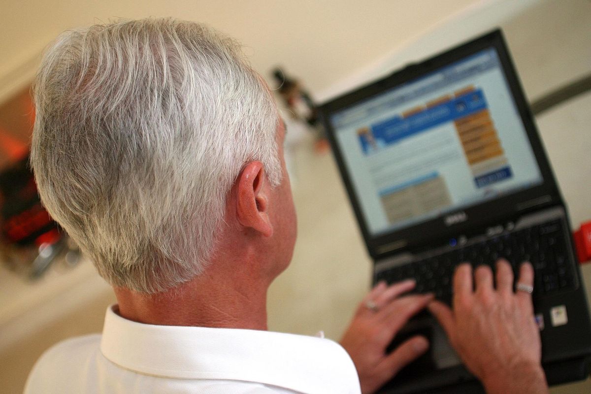 An elderly gentleman surfs the internet