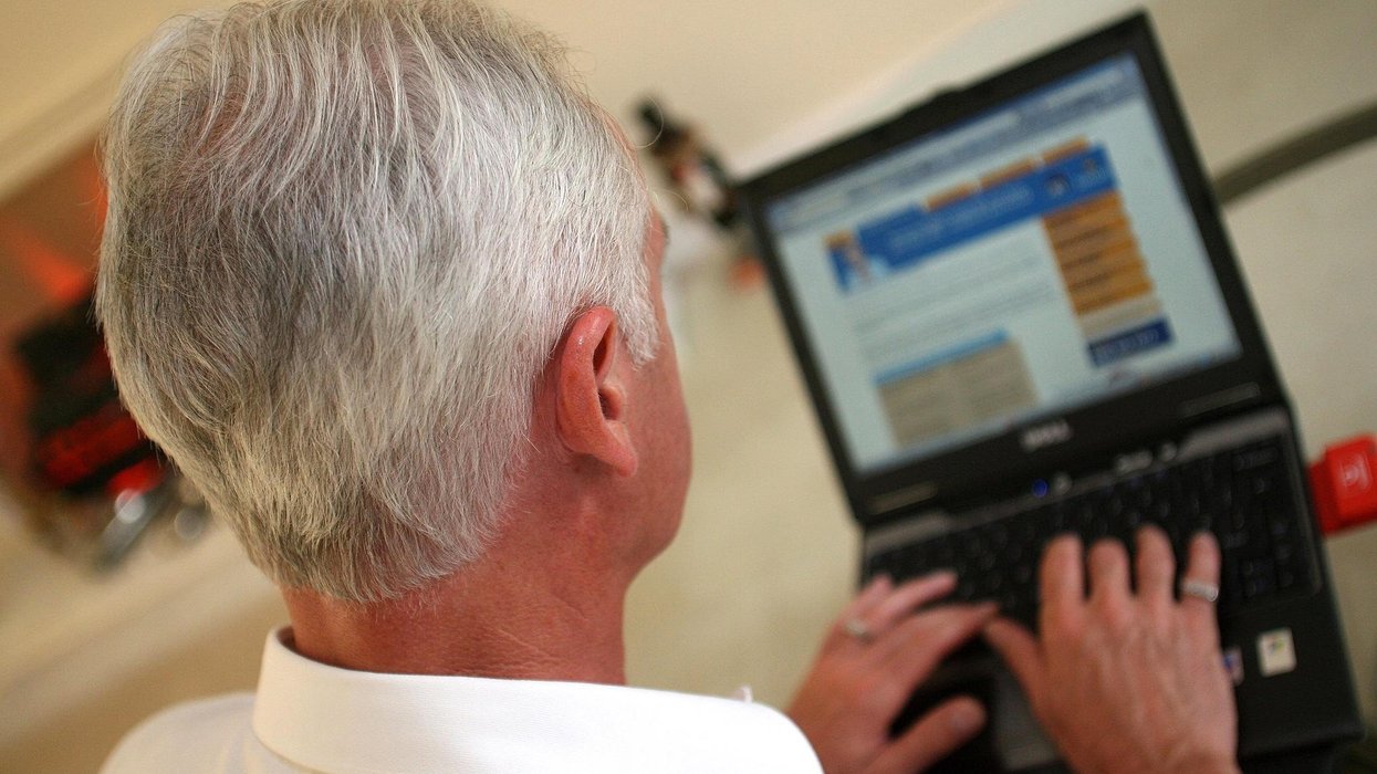 An elderly gentleman surfs the internet