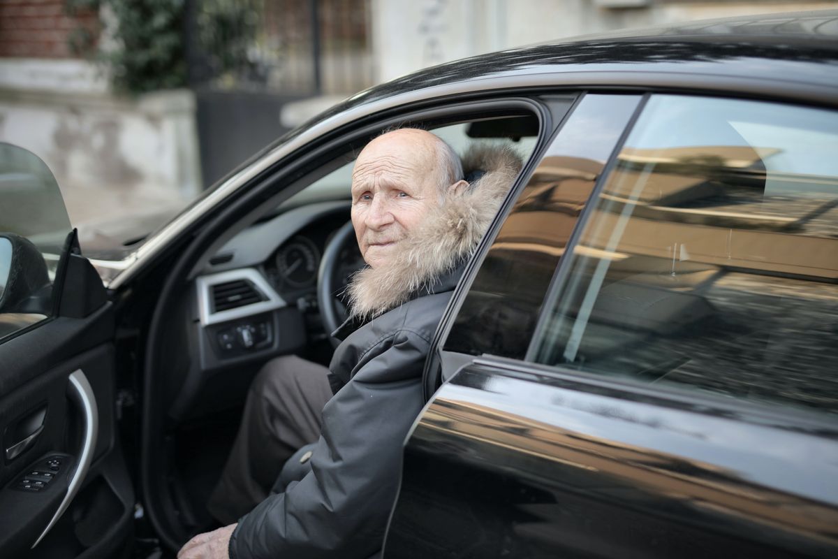 An elderly man driving 