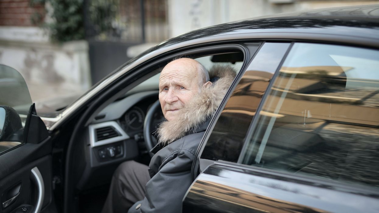 An elderly man driving