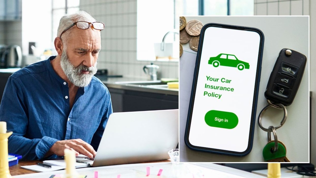 An elderly man looking at a laptop and a car insurance policy