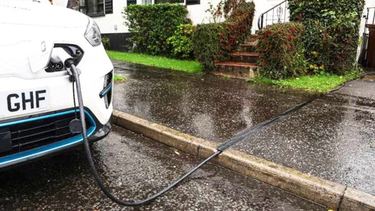 An electric car charging using a Kerbo Charge cross-pavement solution