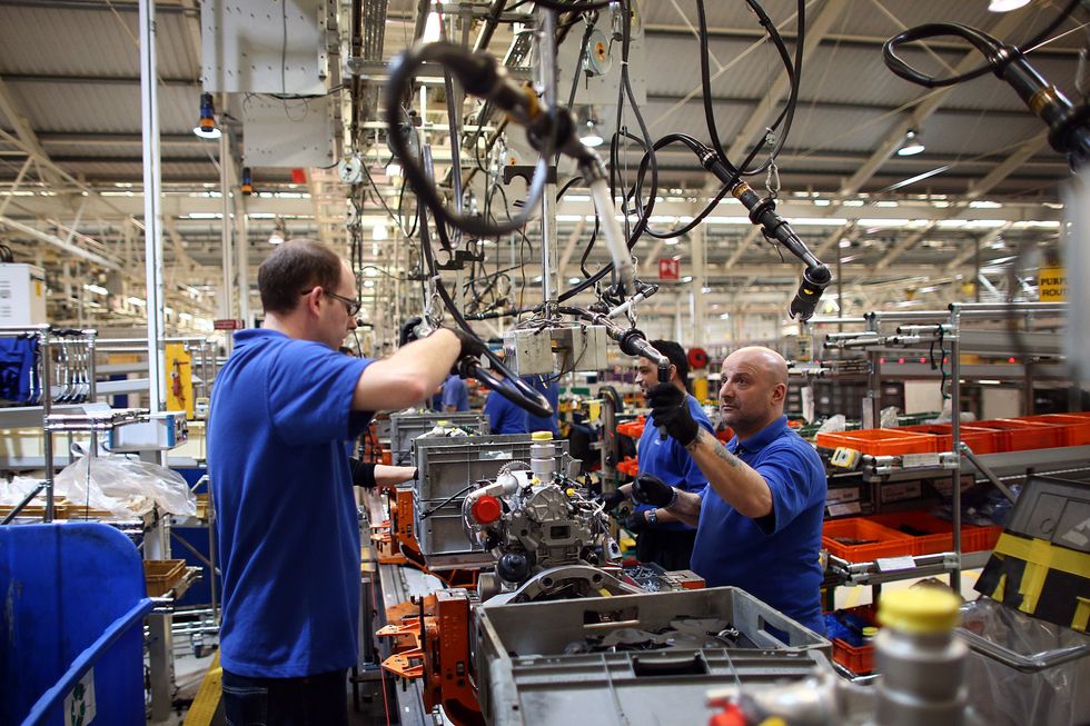 An employee works on an engine production line at a Ford factory on January 13, 2015 in Dagenham, England