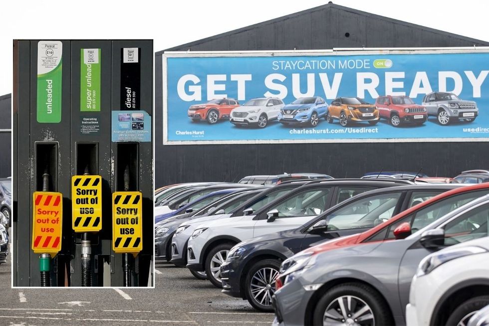 An empty petrol pump and a car dealership lot