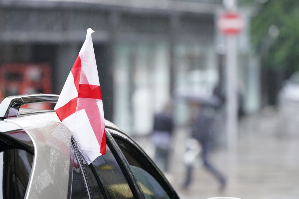 An England flag hanging from a car in Leeds city centre.