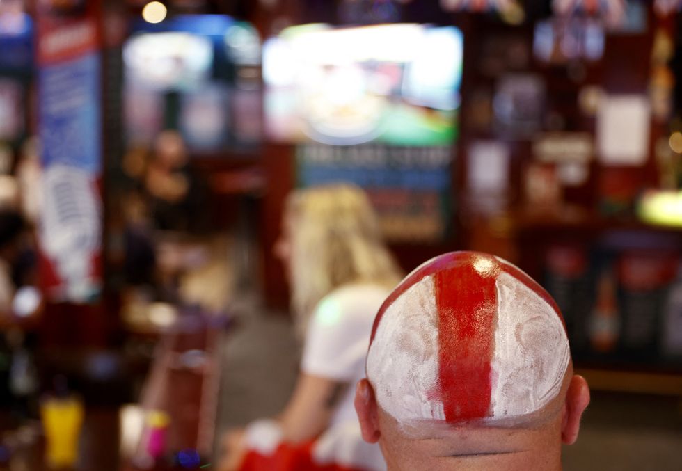 An England flag painted the flag of St George on his head