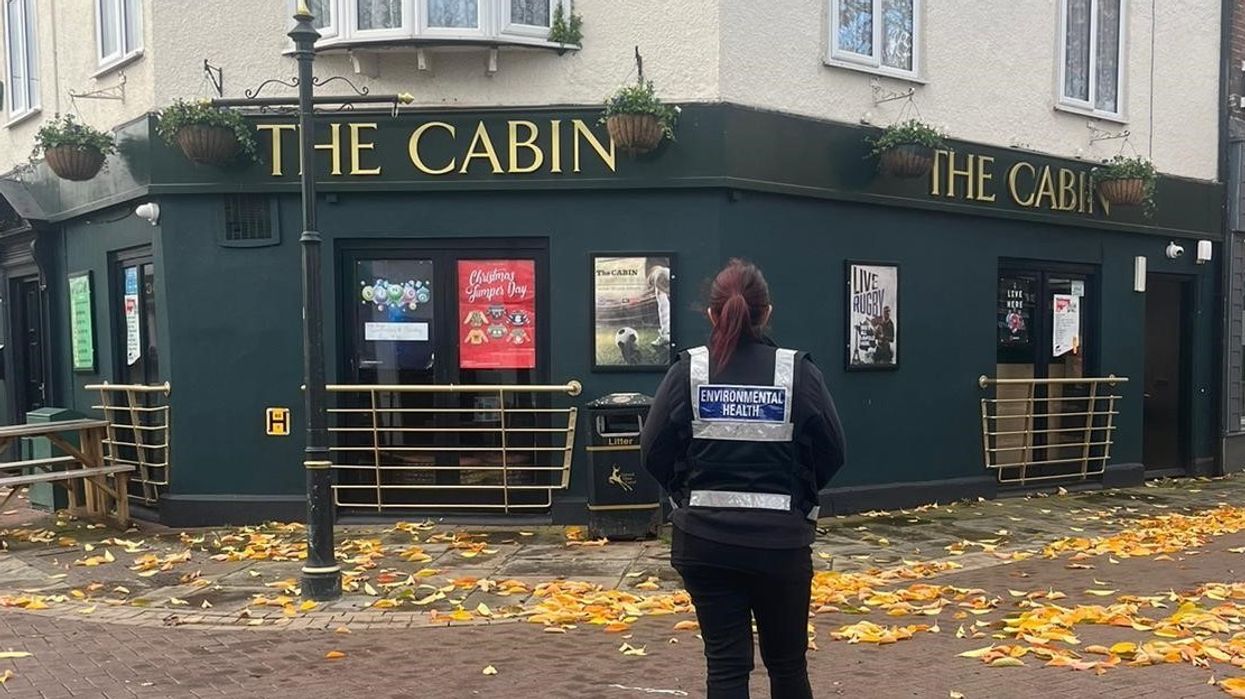 An environmental officer stood outside the pub