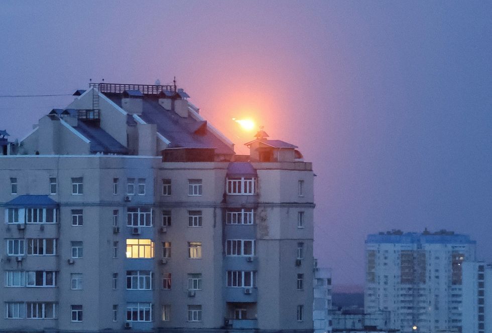 An explosion of a missile is seen in the sky over Kyiv during a Russian missile strike
