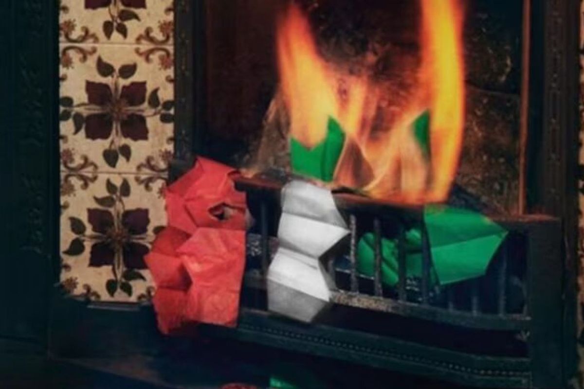 An image from M&S' Christmas outtakes showing festive hats being burnt