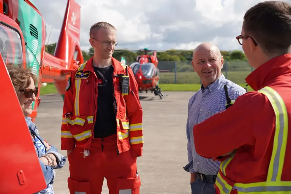 An image of Brendan Clancy meeting Welsh Air Ambulance personnel