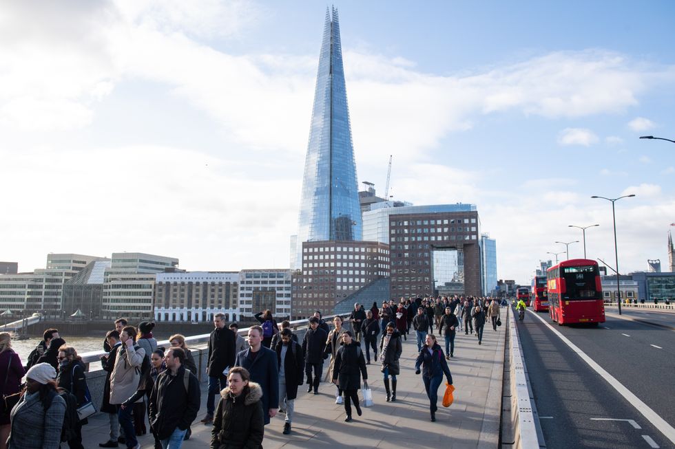 An image of commuters walking across London Bridge