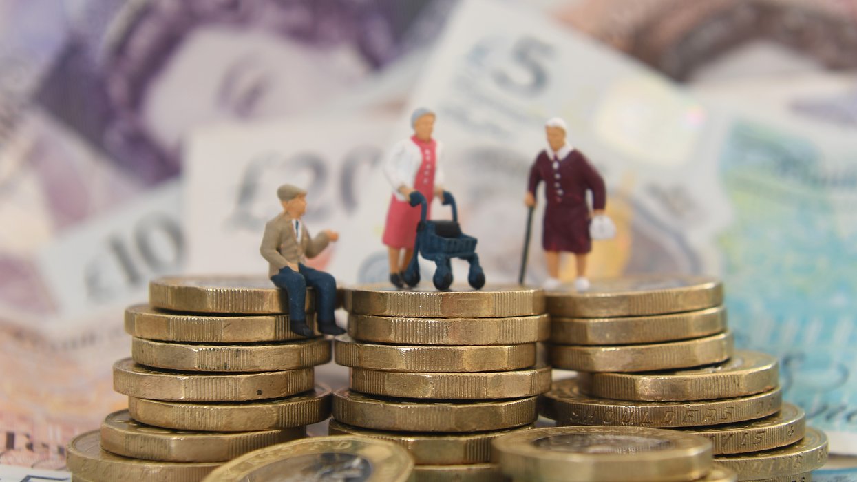 An image of old people figurines stacked on pond coins