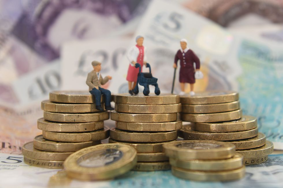 An image of old people figurines stacked on pond coins