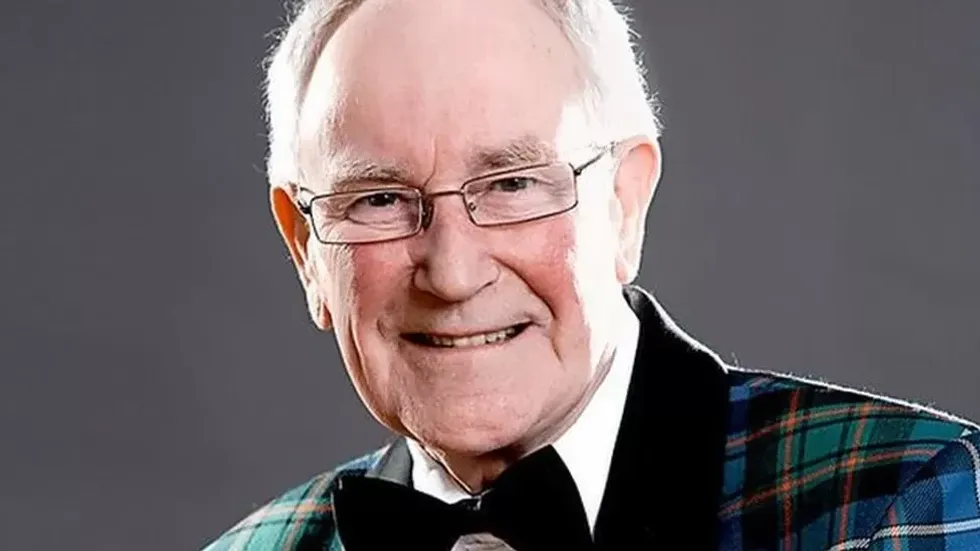 An image of Robbie Shepherd in a tartan blazer