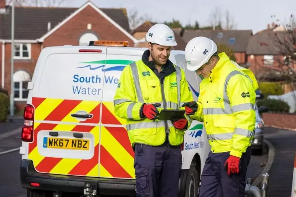 An image of two South West Water workers next to a van
