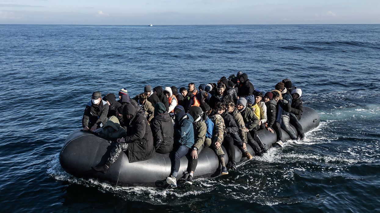 An inflatable dinghy carrying around 65 migrants crosses the English Channel