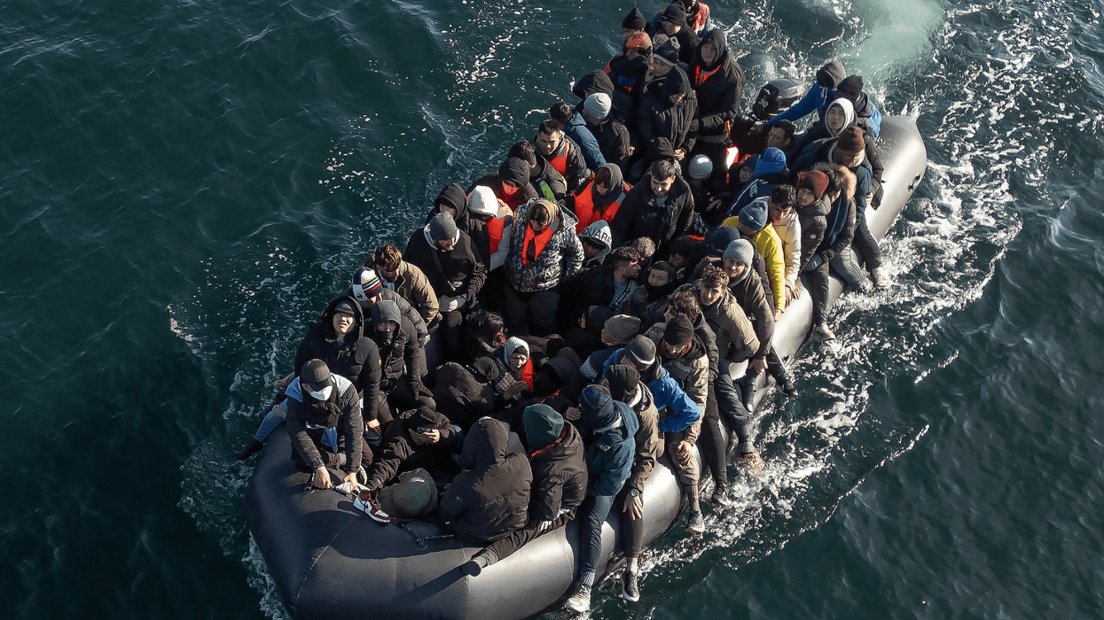 An inflatable dinghy carrying around 65 migrants crosses the English Channel
