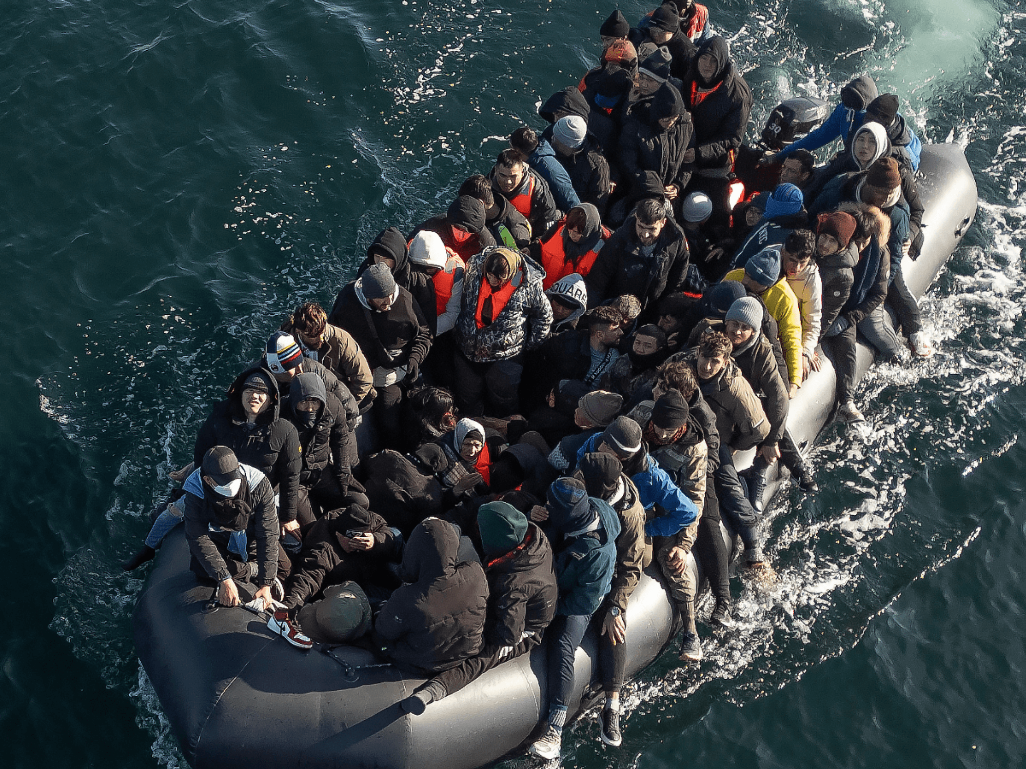 An inflatable dinghy carrying around 65 migrants crosses the English Channel