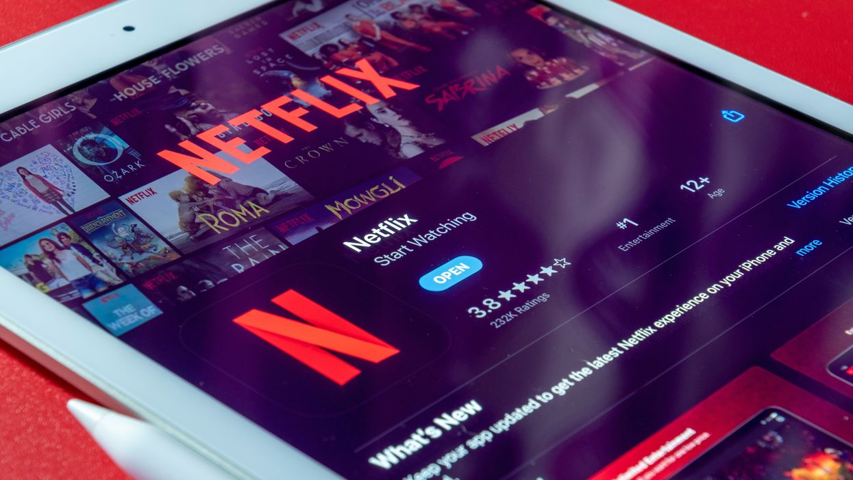 an ipad is pictured with the app store listing for netflix on-screen