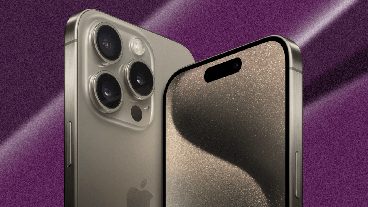 an iphone 15 pro in natural titanium finish pictured in the foreground with a colourful background