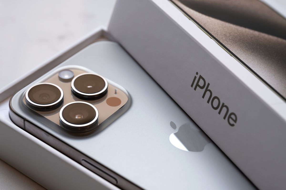 an iphone 15 pro is pictured resting inside its packaging 