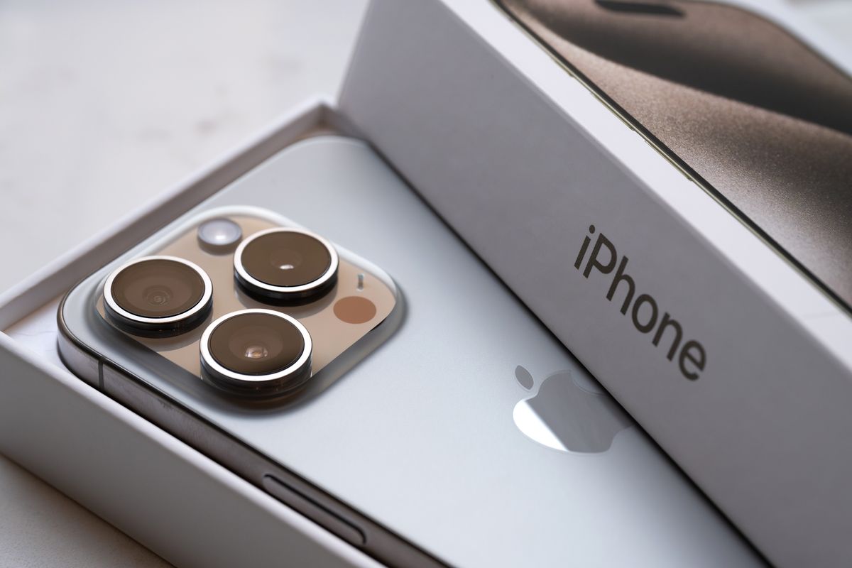 an iphone 15 pro is pictured resting inside its packaging 