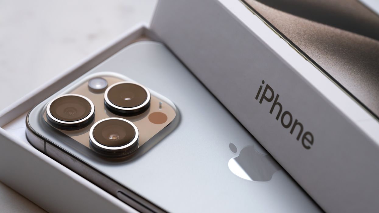 an iphone 15 pro is pictured resting inside its packaging