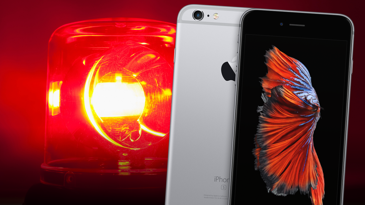 an iphone 6 plus pictured in space grey with a warning siren pictured in the background