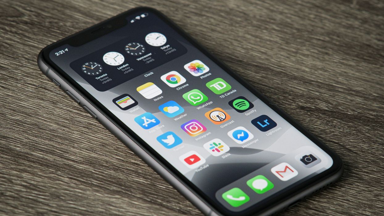an iphone pictured lying on a wooden table