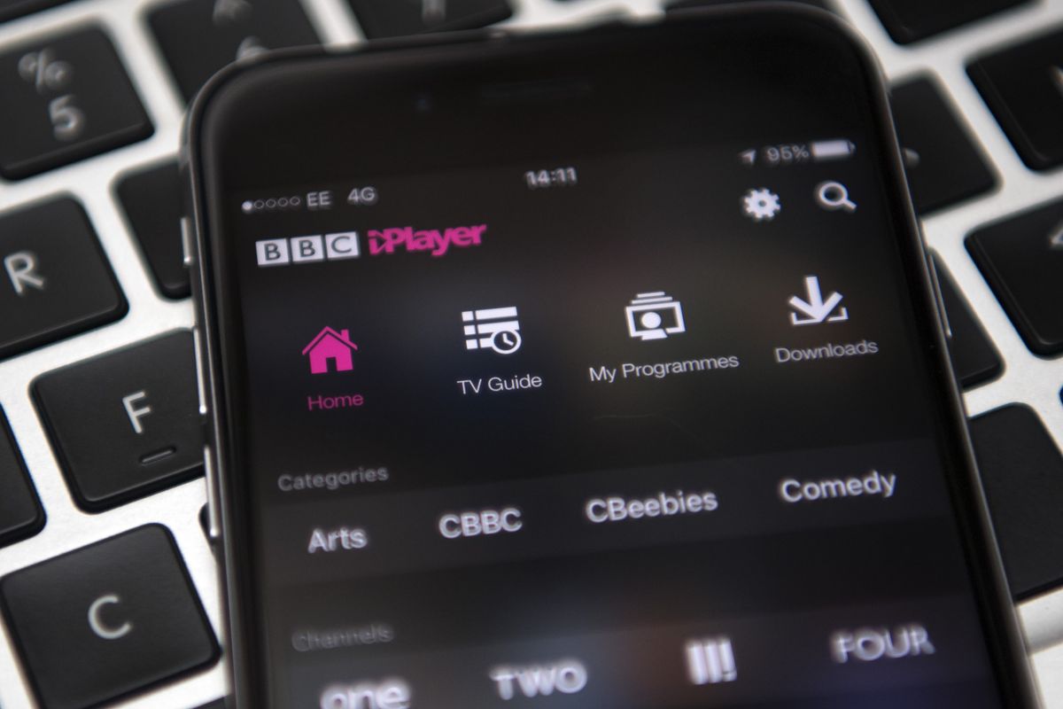 an iphone running bbc iplayer pictured lying on a keyboard