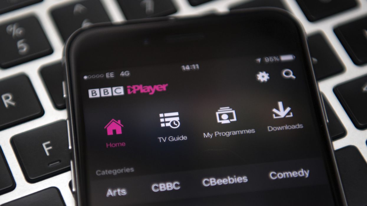 an iphone running bbc iplayer pictured lying on a keyboard