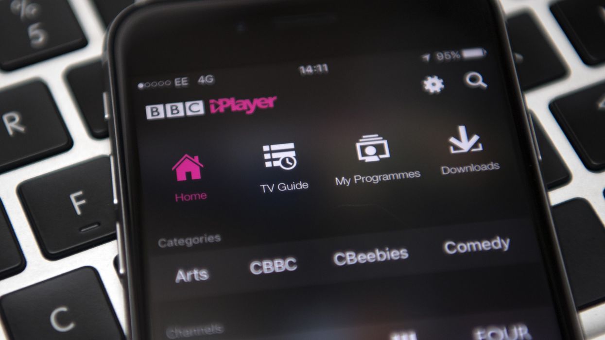 an iphone running bbc iplayer pictured lying on a keyboard