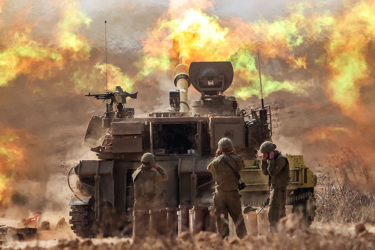 An Israeli army M109 155mm self-propelled howitzer fires rounds near the border with Gaza