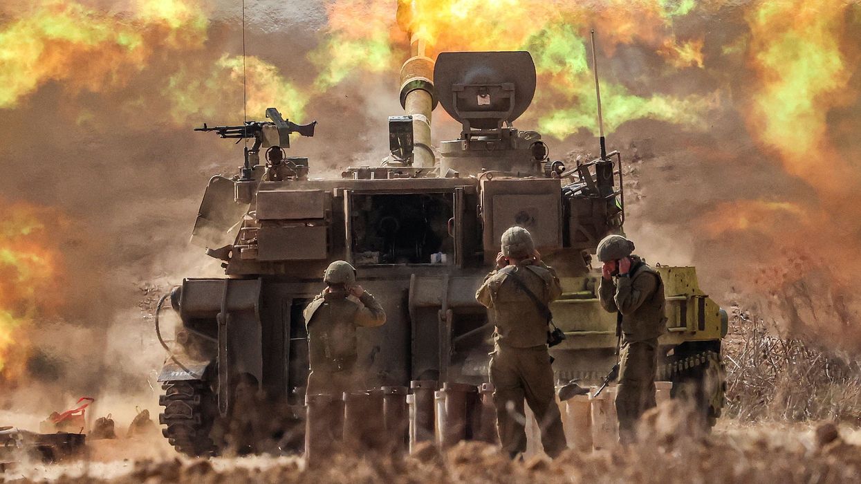 An Israeli army M109 155mm self-propelled howitzer fires rounds near the border with Gaza