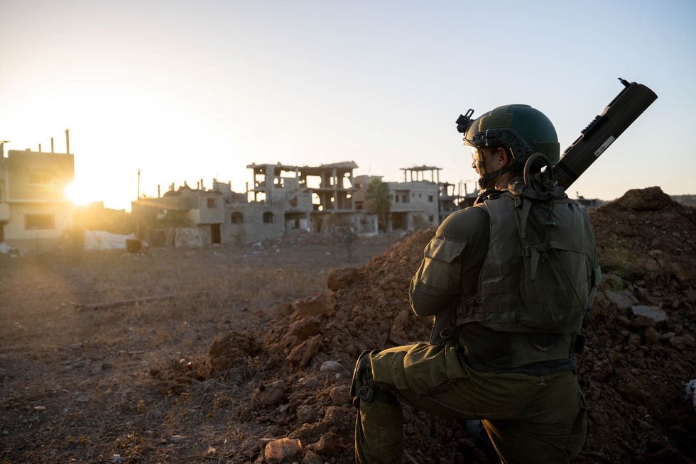 An Israeli soldier takes position during the ongoing ground operation of the Israeli army against Palestinian Islamist group Hamas