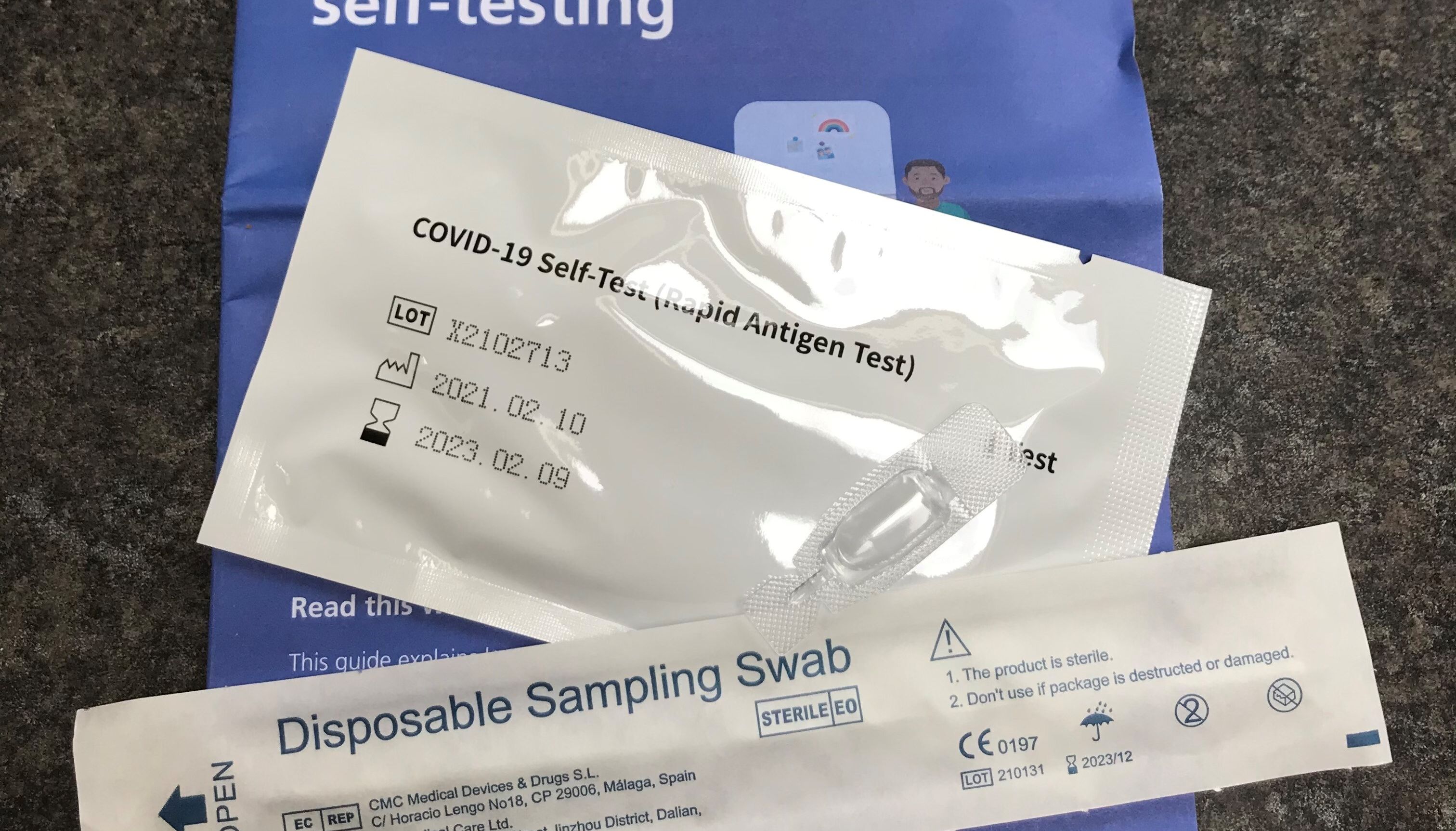 An NHS Test and Trace COVID-19 self-testing kit (Rapid Antigen Test) which has been received through the mail after ordering online for use at home - people in Wales will be required to take one in order to enter large scale events.