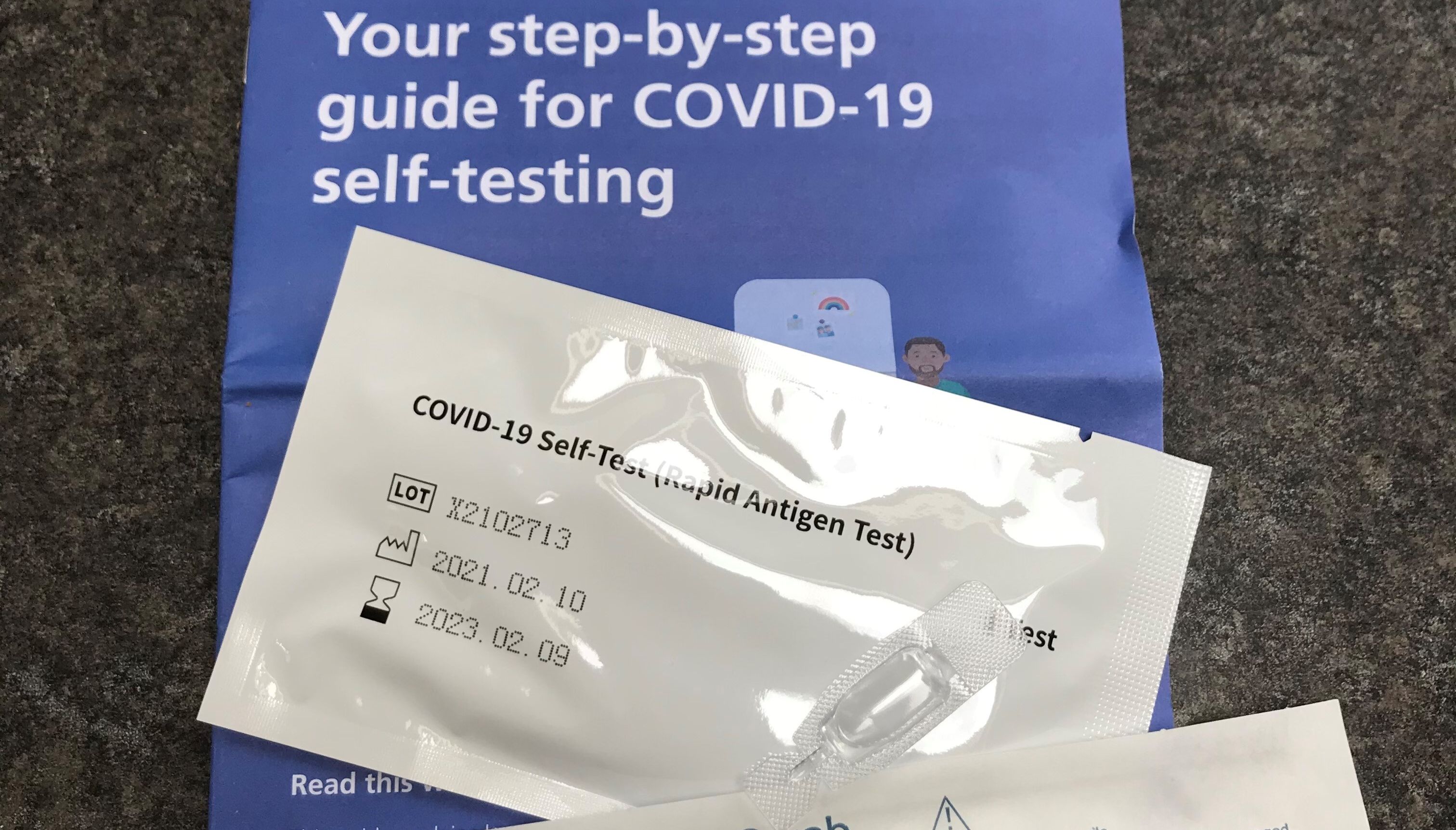 An NHS Test and Trace COVID-19 self-testing kit (Rapid Antigen Test) which has been received through the mail after ordering online for use at home.