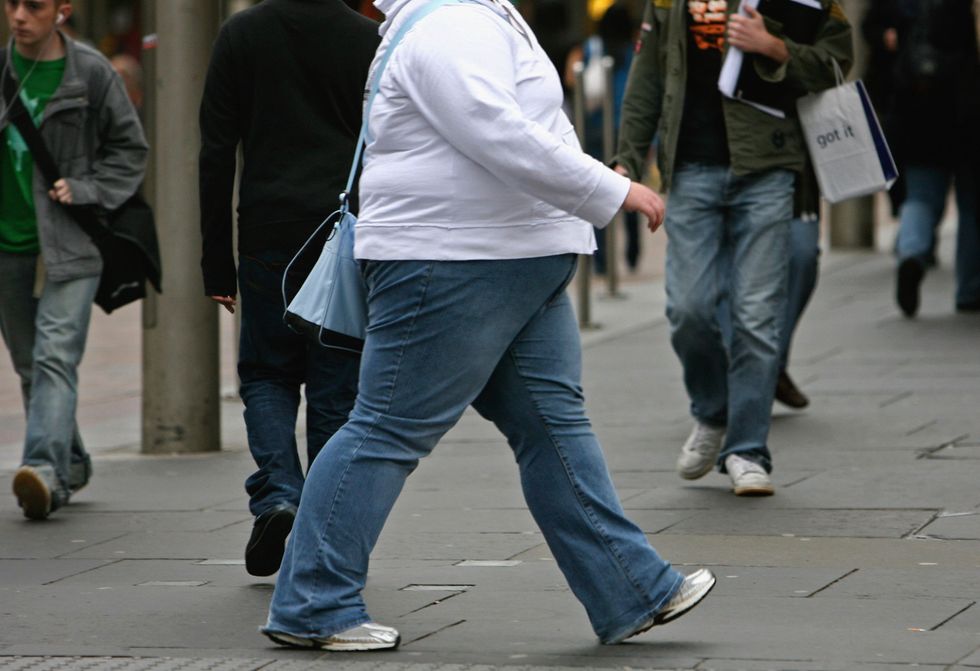 An obese person walking