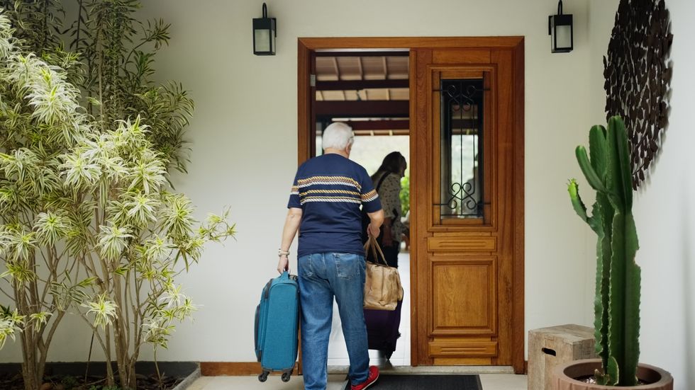 An old man returning home from holiday