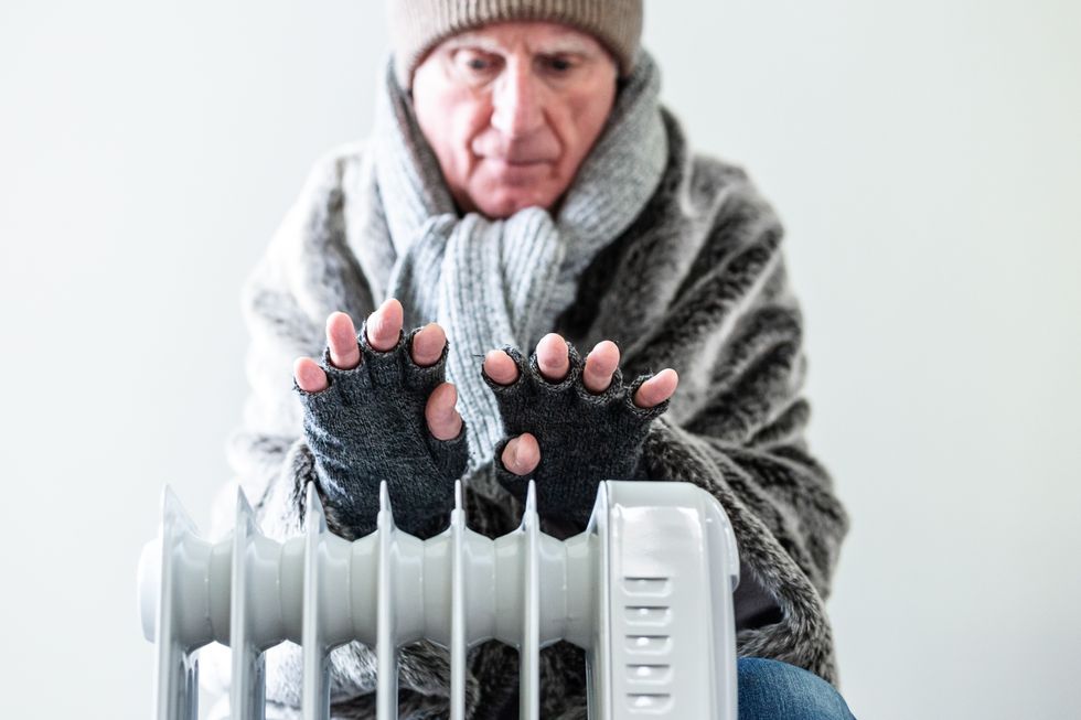 An older man trying to keep warm