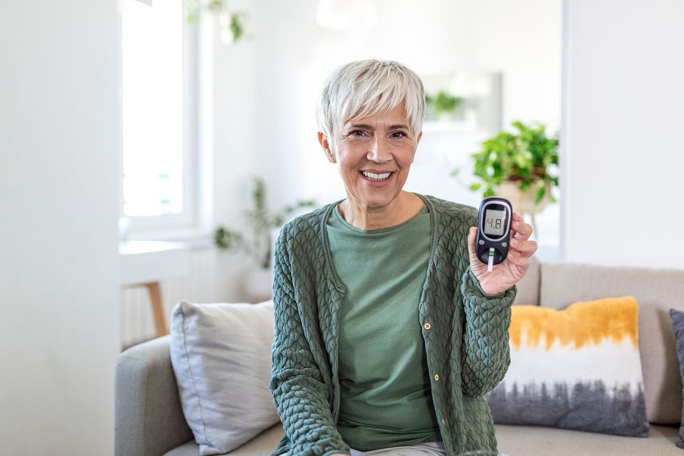 An older woman performing an at-home blood sugar test