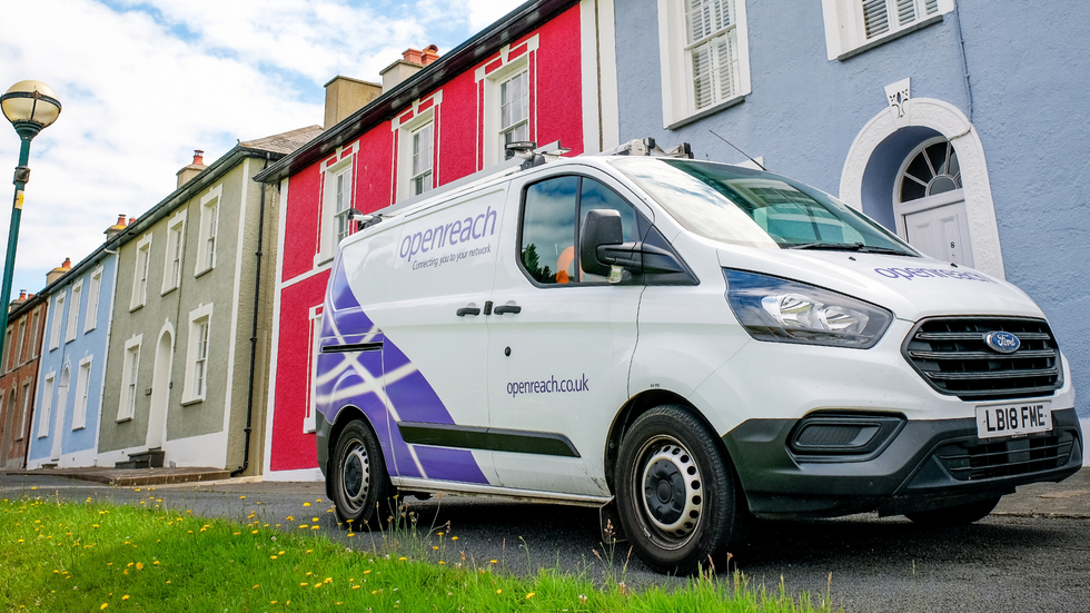 an openreach branded van is pictured parked outside a row of colourful houses 
