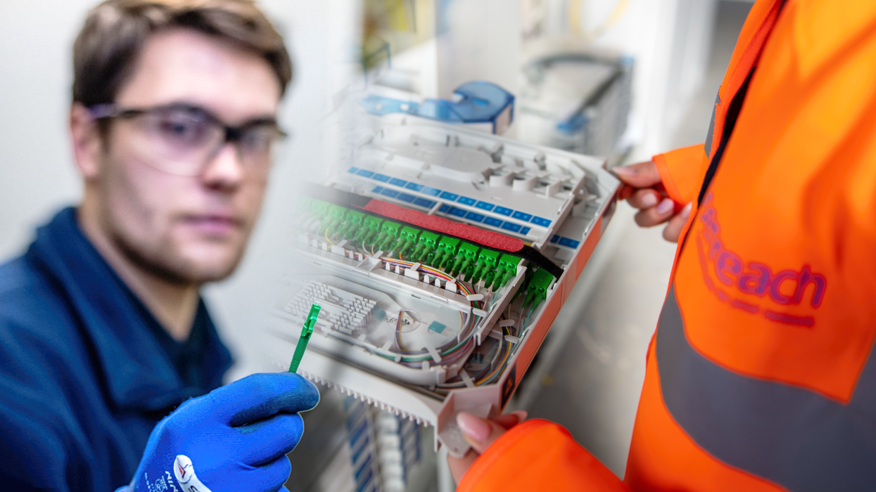 an openreach engineer holding a cable and employee in orange high-visibility jacket