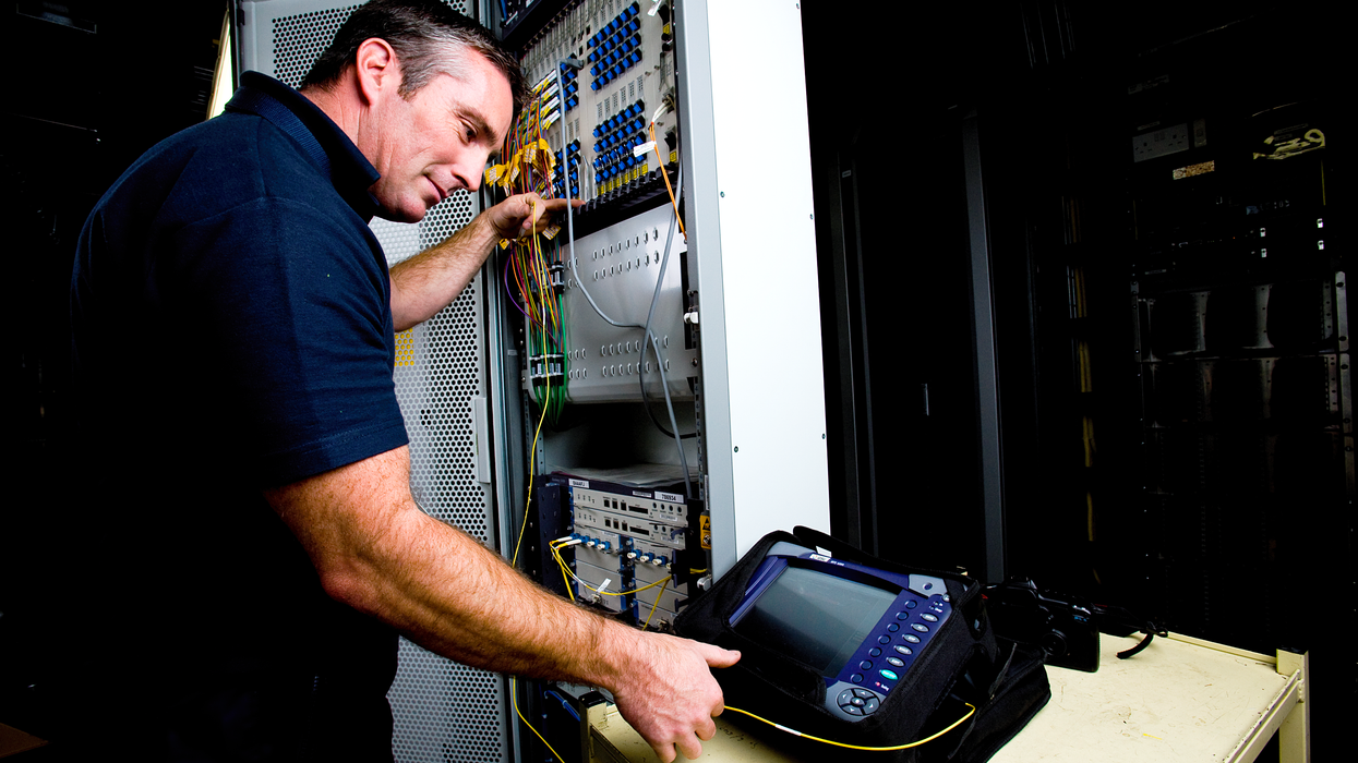 an openreach engineer pictured testing the new broadband technology that enables faster download speeds over the existing full-fibre connection