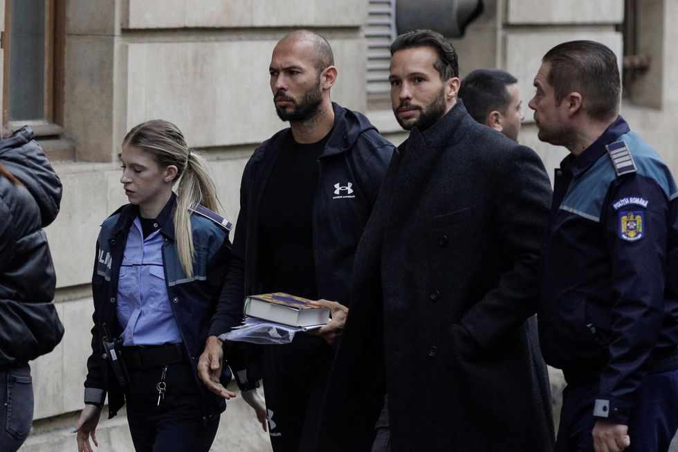 Andrew Tate and his brother Tristan escorted by police officers outside the Bucharest Court of Appeal