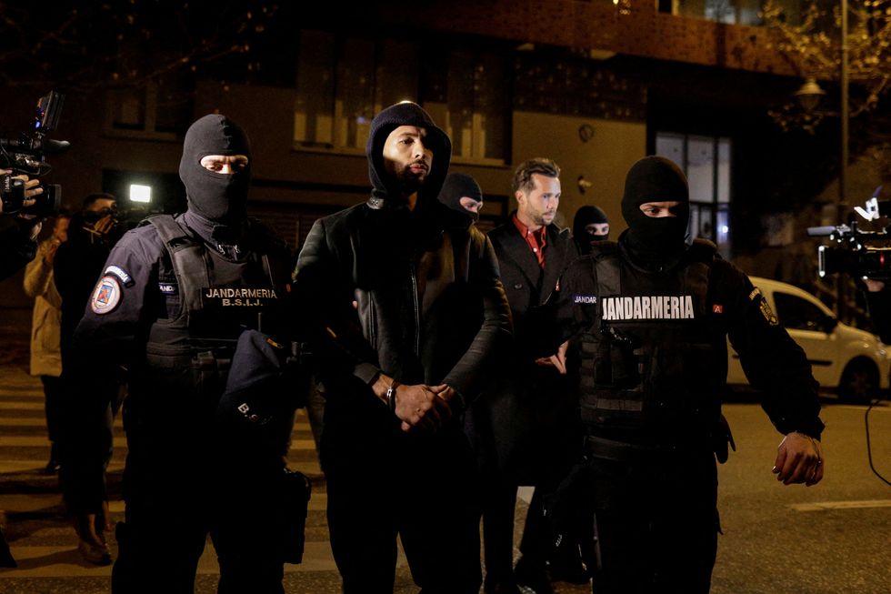 Andrew Tate and Tristan Tate are escorted by police officers outside the headquarters of the Directorate for Investigating Organized Crime and Terrorism in Bucharest (DIICOT) after being detained for 24 hours, in Bucharest,\u00a0Romania, December 29, 2022. Inquam Photos/Octav Ganea via REUTERS ATTENTION EDITORS - THIS IMAGE WAS PROVIDED BY A THIRD PARTY. ROMANIA OUT. NO COMMERCIAL OR EDITORIAL SALES IN ROMANIA TPX IMAGES OF THE DAY