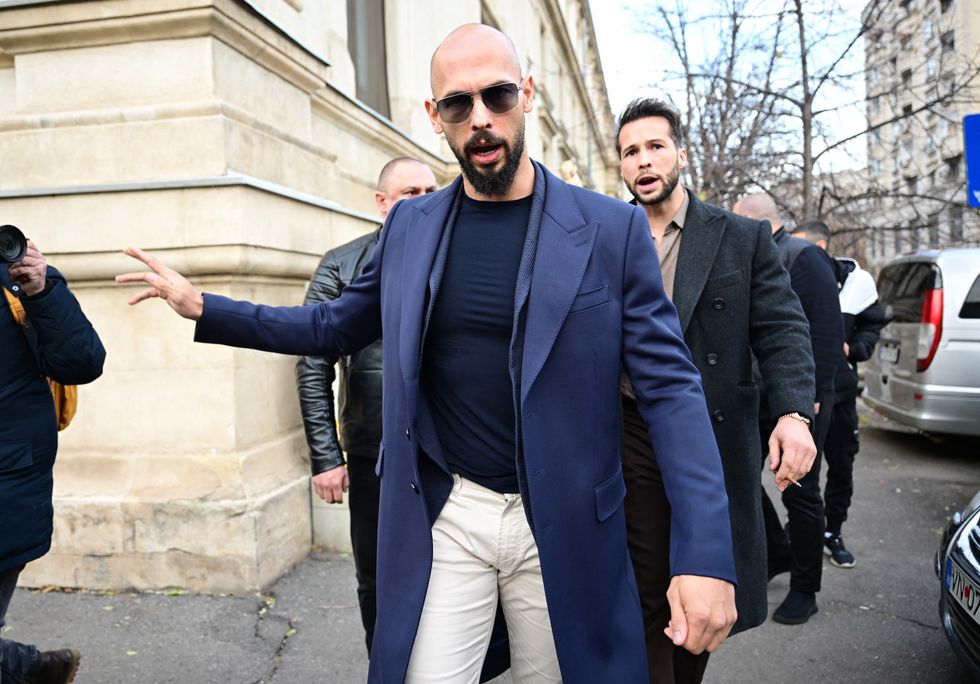 Andrew Tate (L) and Tristan Tate (R) walk from the Bucharest's Court of Appeal