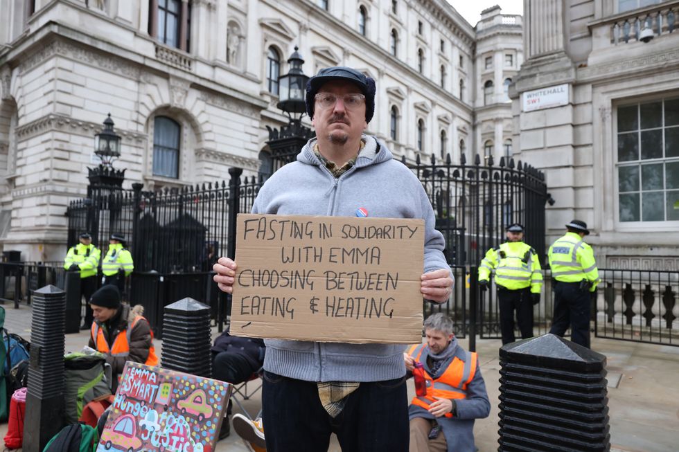 Andy Smith, the husband of jailed protester Emma Smith, stands with a placard as supporters of Insulate Britain stage a 24 hour fast outside Downing Street, London, in a call for action on fuel poverty.