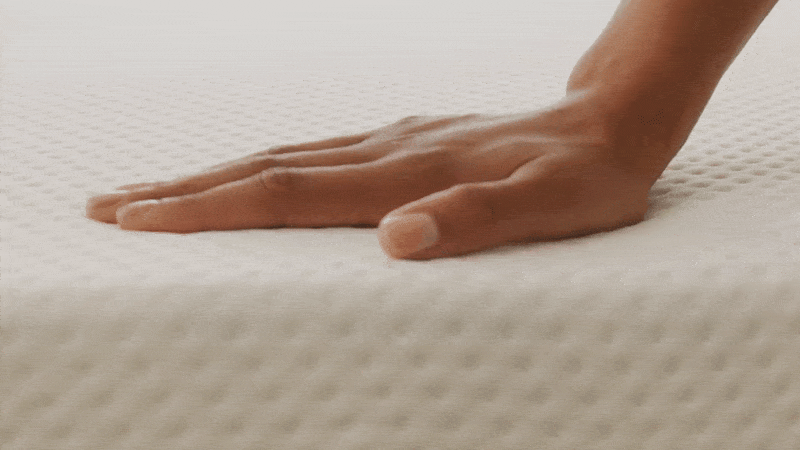 animated gif of a hand testing the softness of a memory foam mattress